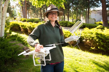 GIS student holding a drone at a community college