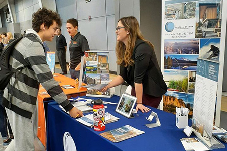 Speaking with students at a college fair