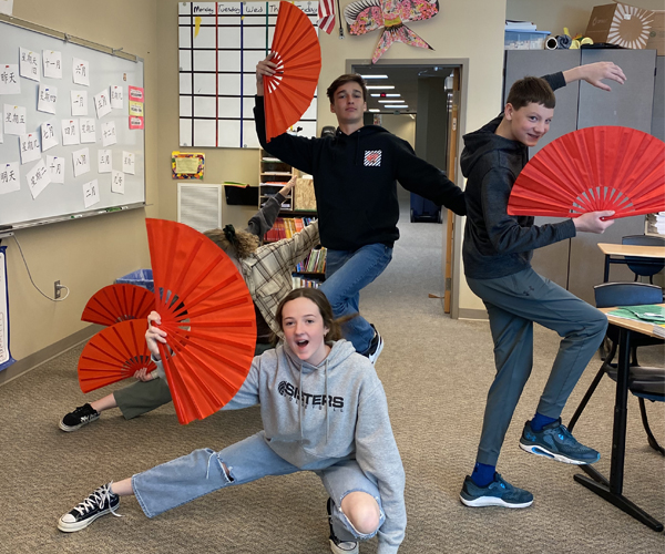 Students dancing with fans in Chinese language immersion class
