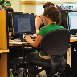 Photo of a student working on a computer at Barber Library