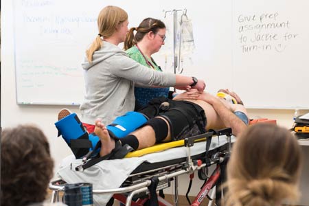 Emergency medical services students learning in the classroom with subject