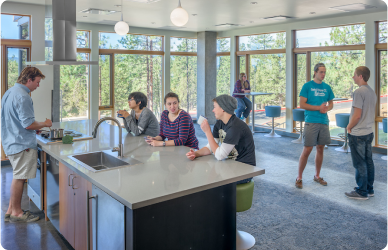 Community college student residents gathered in Wickiup Hall community kitchen