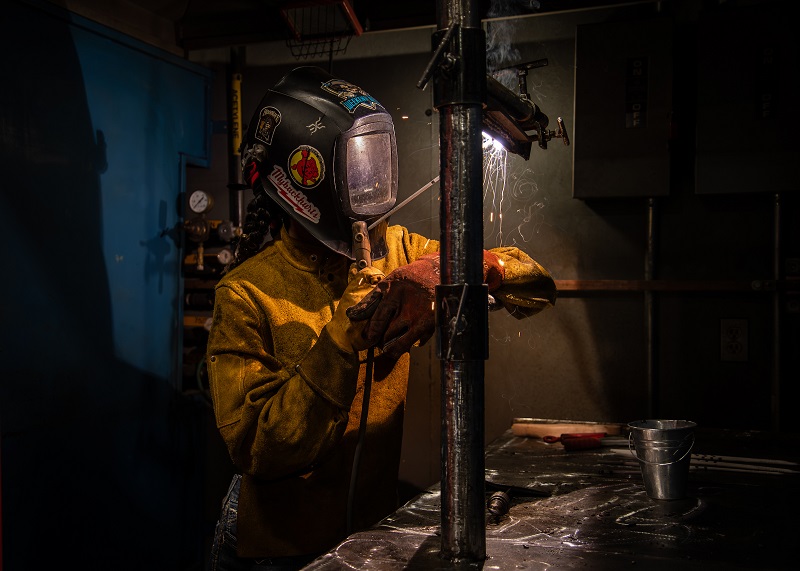 Shayla Simms perfecting her skills in a COCC Welding lab
