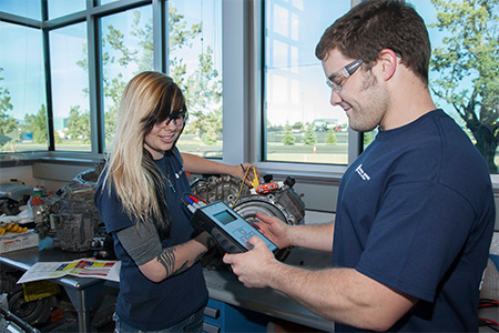 COCC Automotive students exchanging notes in the classroom.