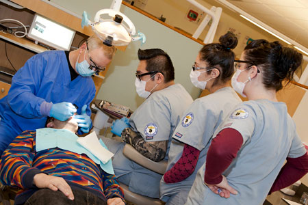 COCC faculty and students working on a patient at the COCC dental clinic