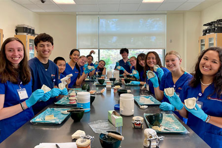 Group of dental assisting students at Central Orgeon Community College making dental impressions