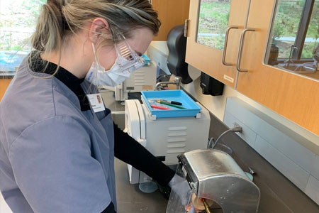 Dental Assisting student working on machine