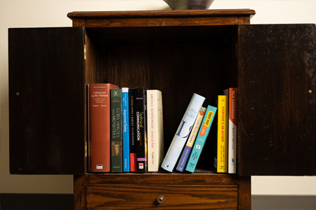 Book shelf with various humanities subject textbooks