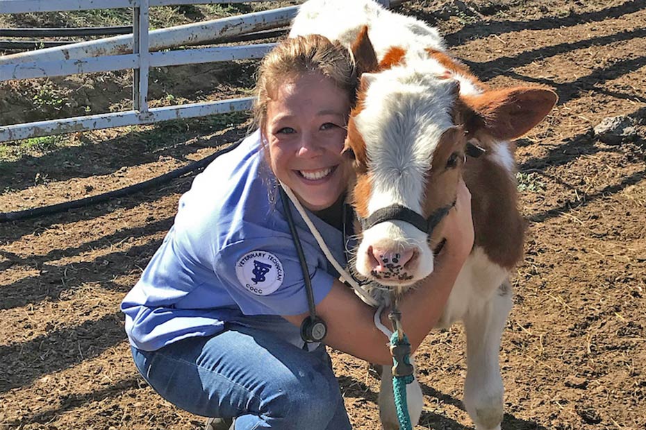 COCC vet tech student hugging calf